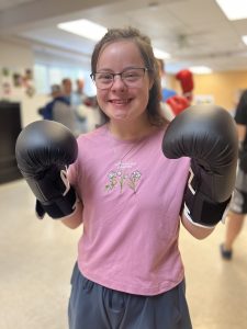 Person served smiling holding boxing gloves on!