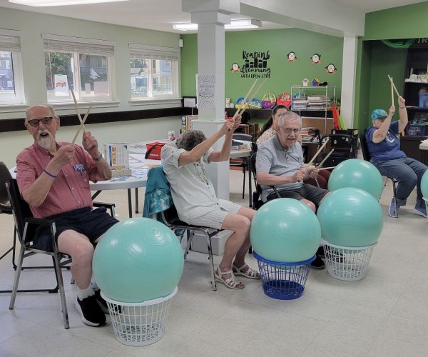 Seniors drumming on exercise balls