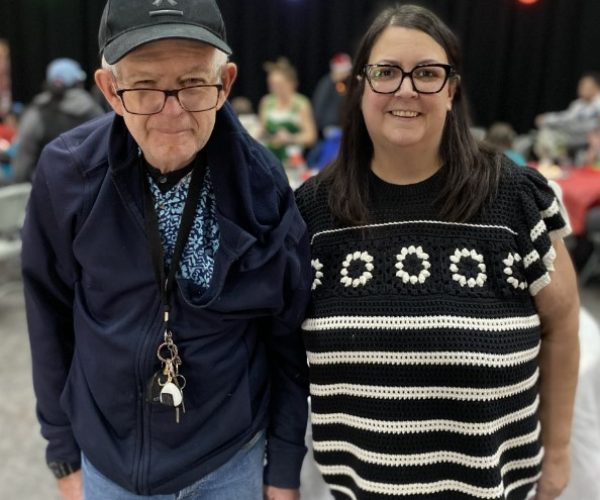 home share manager with person served at Christmas party.